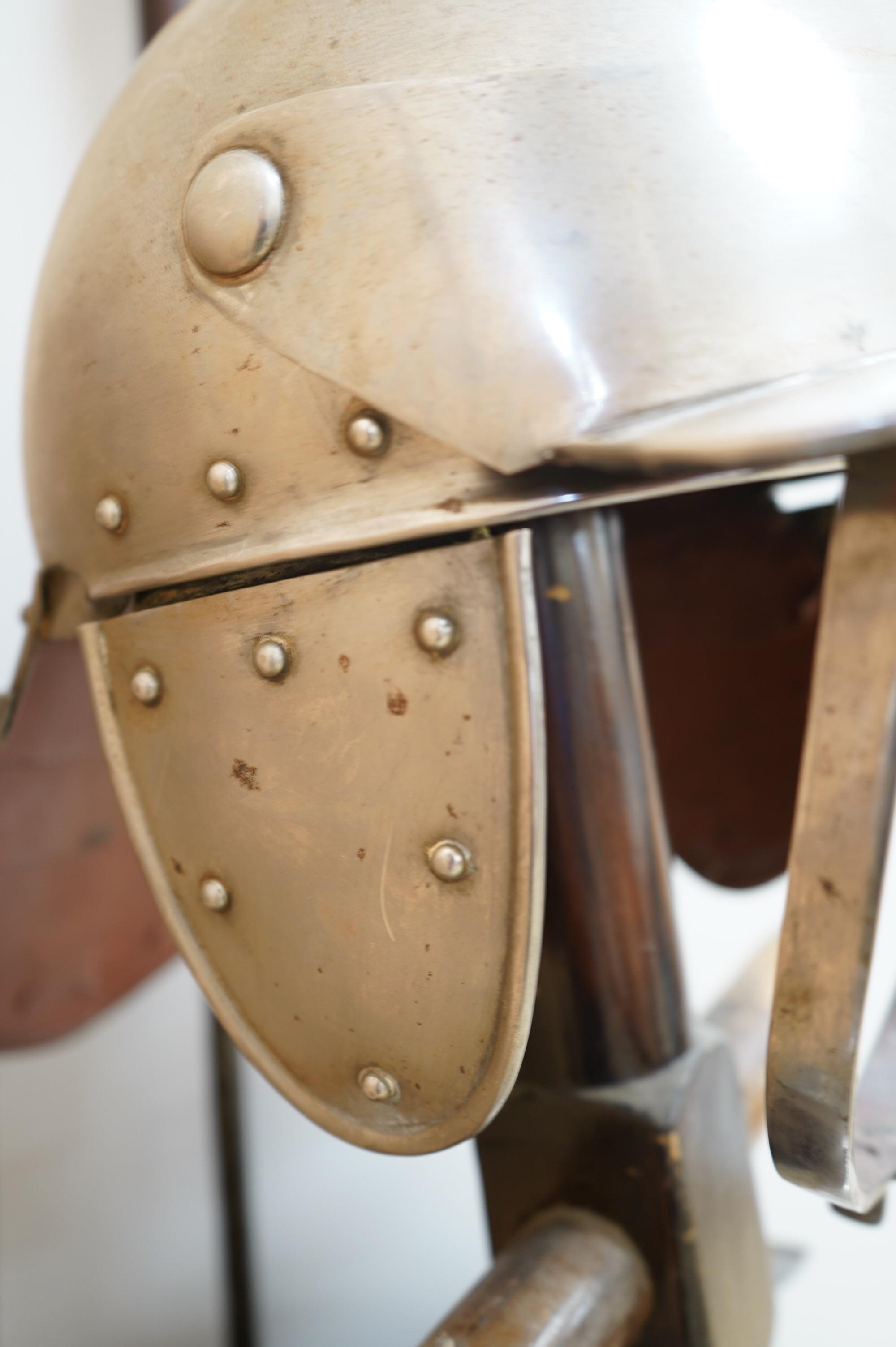 A replica suit of English Civil War armour on a stand, comprising; a lobster pot helmet, breastplate and back plate. Condition - poor to fair